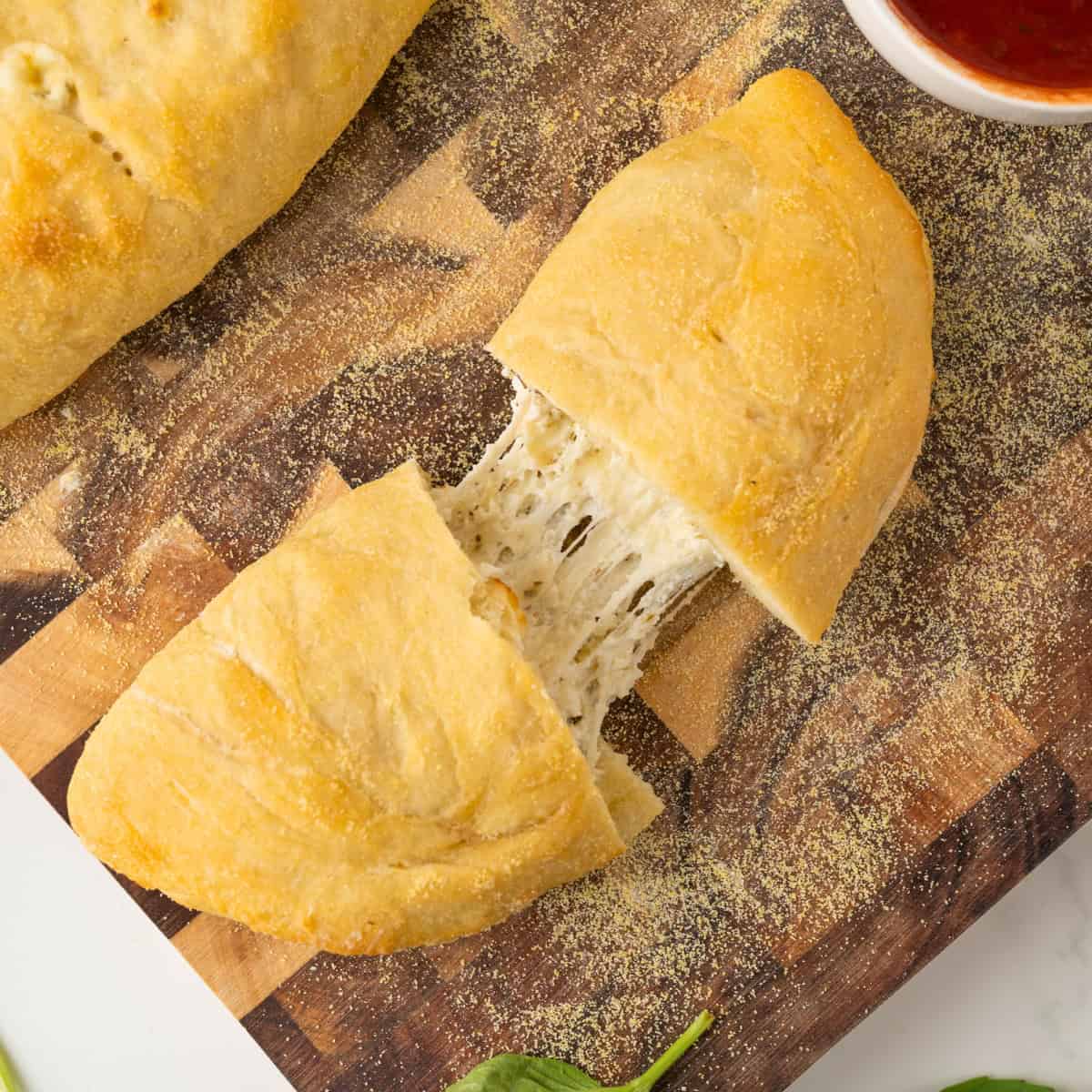sliced cheese calzone on a cutting board
