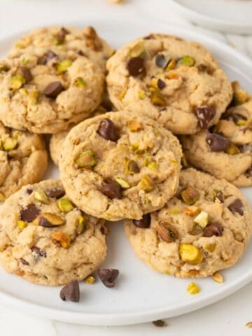 chocolate chip pistachio cookies on a white plate
