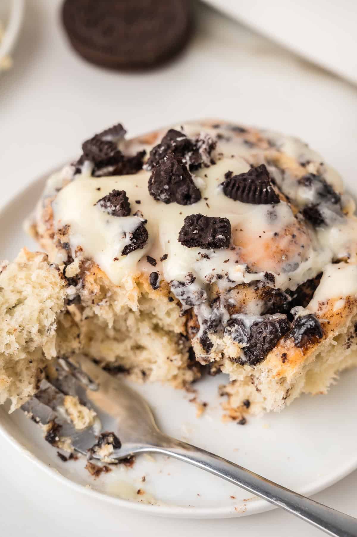 Oreo cinnamon roll sliced on a white plate