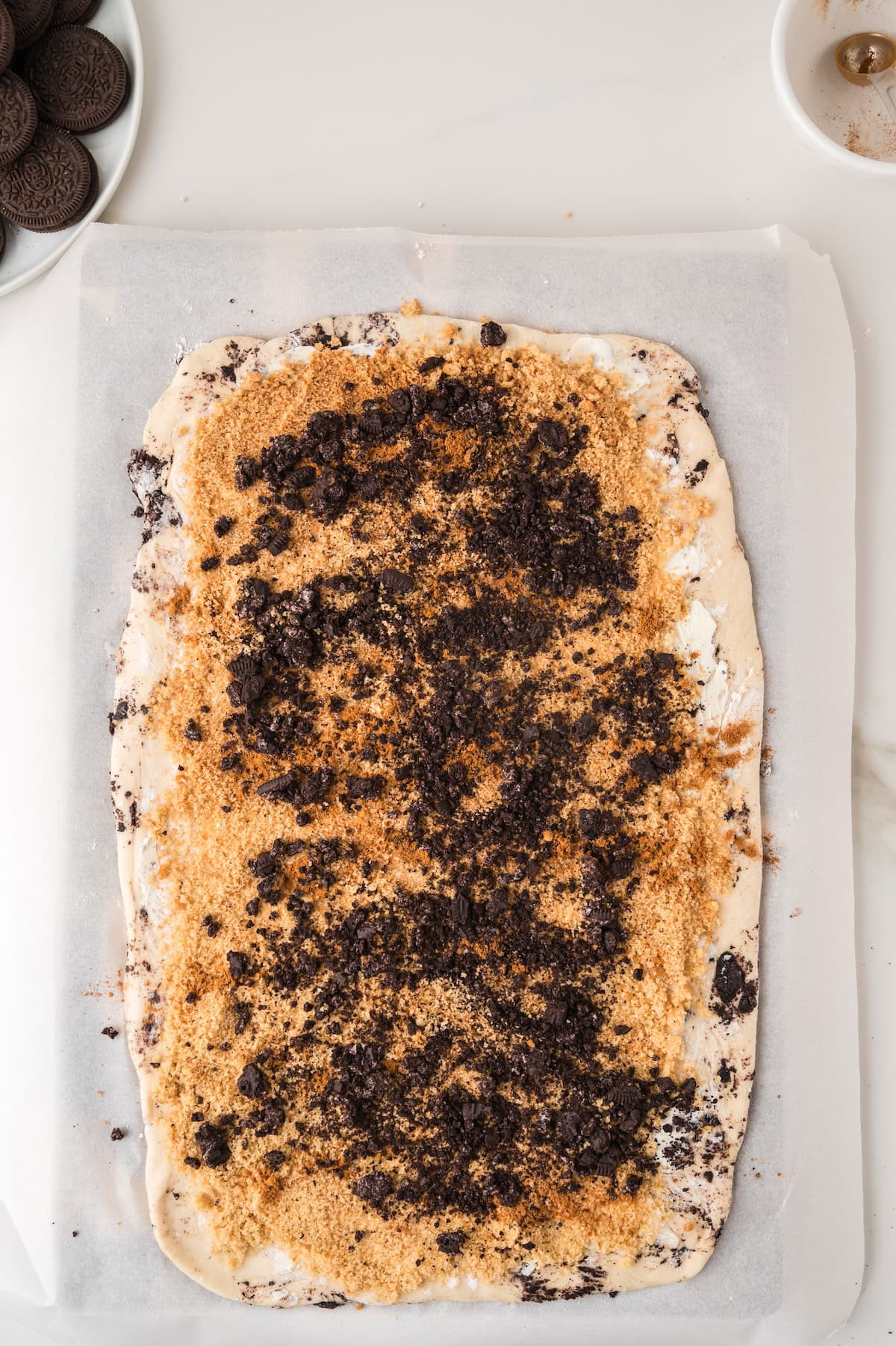 cinnamon rolls topped with sugar filling in a casserole dish