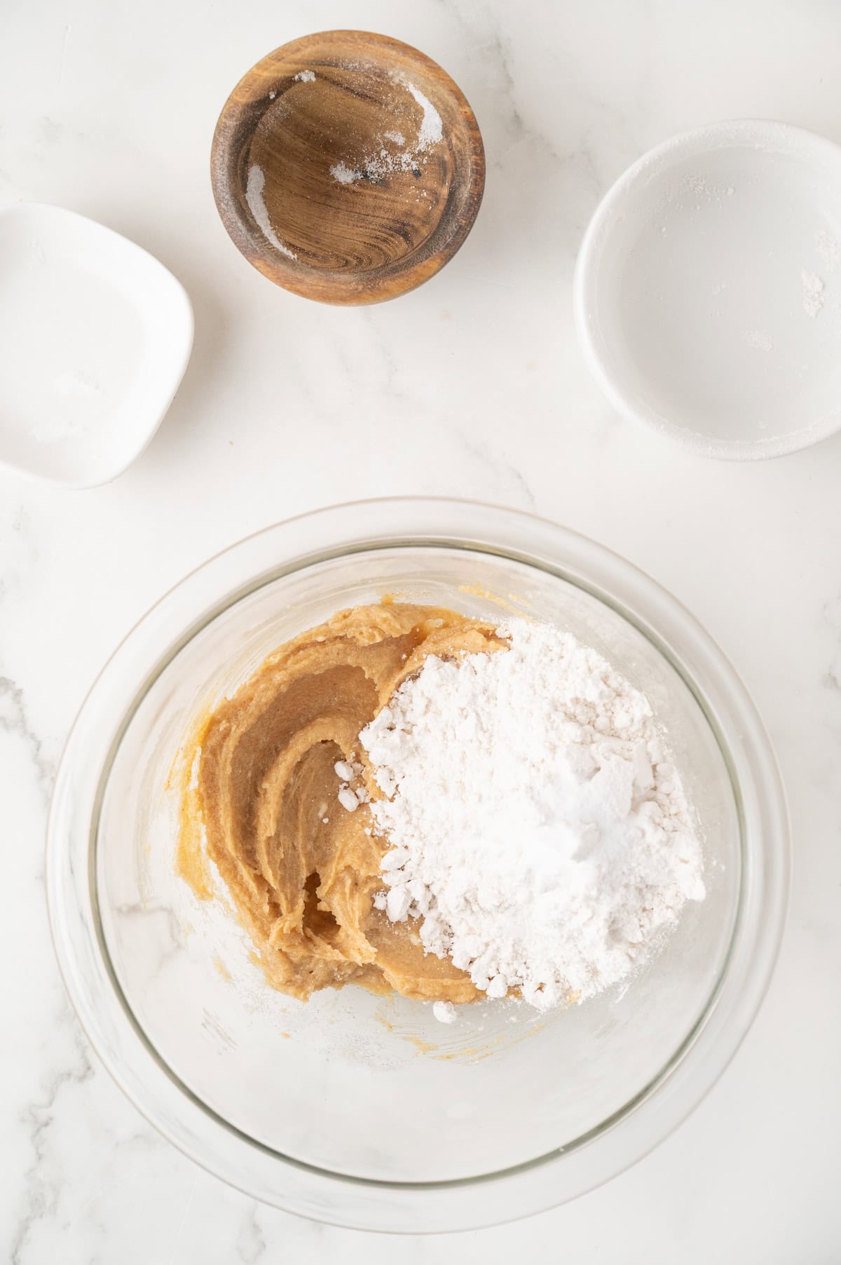 sugar, flour and peanut butter cookie dough in a mixing bowl