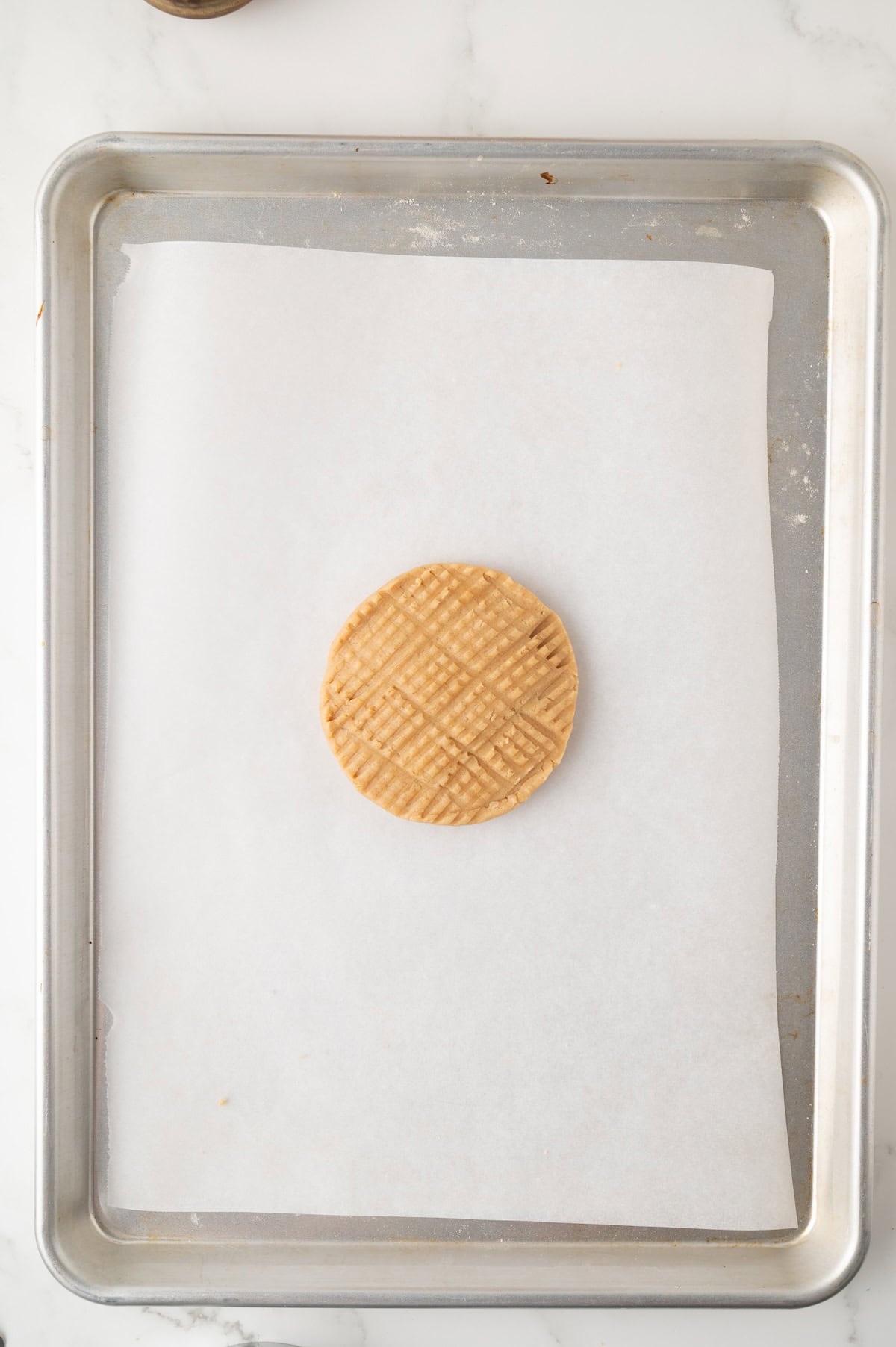 uncooked single serve peanut butter cookie on a baking sheet