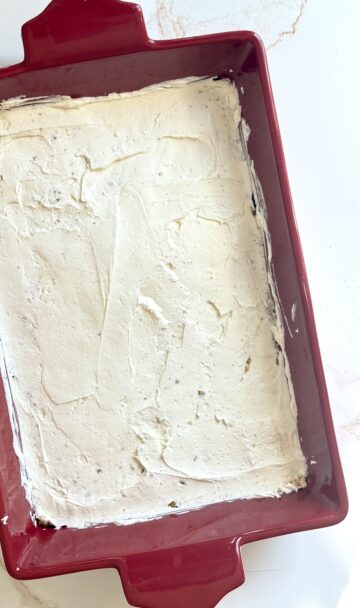 cream cheese layered on graham crackers in a baking dish