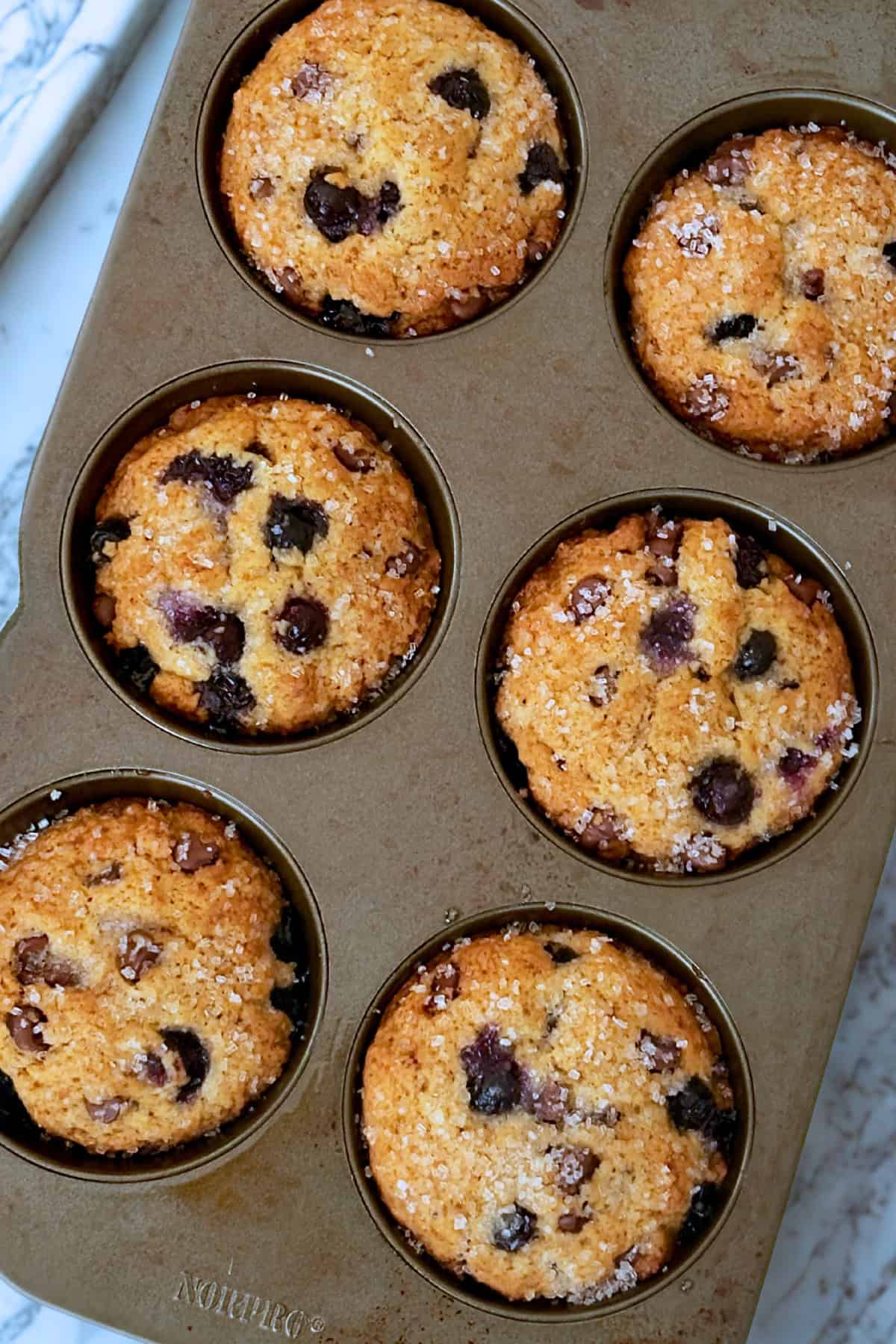 baked blueberry chocolate muffins in a jumbo muffin tin