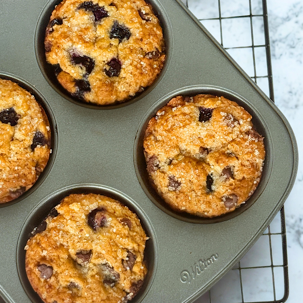 blueberry chocolate chip muffins in a baking pan