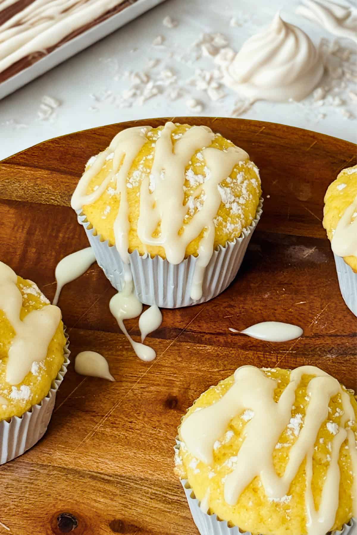 glazed lemon muffins on a serving board